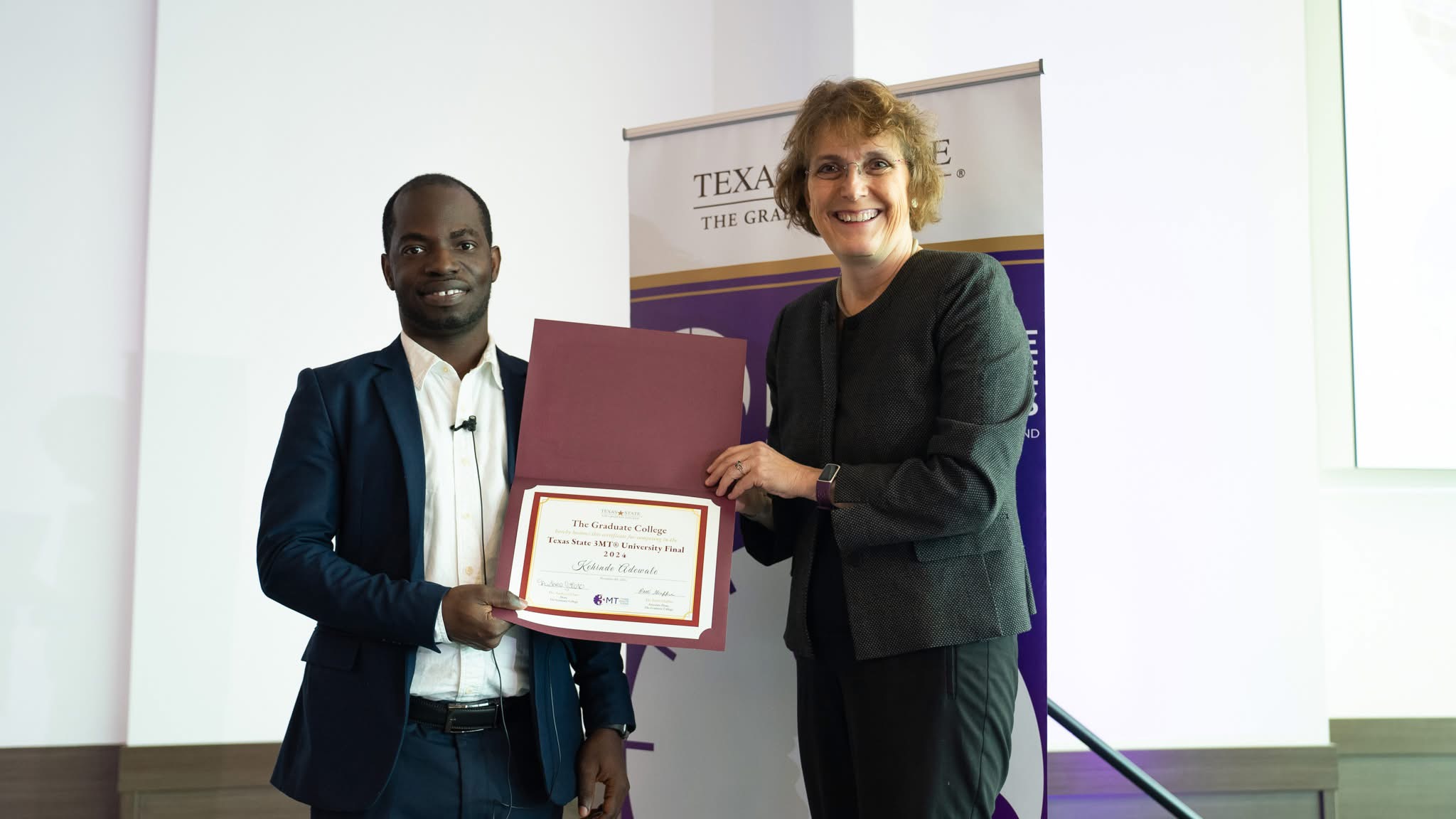 Kehinde Adewale receiving his Texas State University 3MT finalist certificate